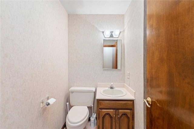 bathroom with toilet and vanity