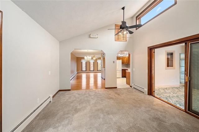unfurnished living room with arched walkways, a baseboard radiator, light colored carpet, and ceiling fan with notable chandelier