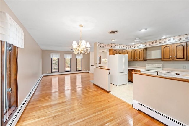 kitchen featuring visible vents, a baseboard radiator, light countertops, white appliances, and light wood finished floors