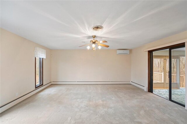 spare room with a wealth of natural light, visible vents, and a ceiling fan