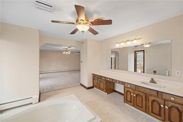 bathroom with vanity, visible vents, baseboard heating, and ceiling fan