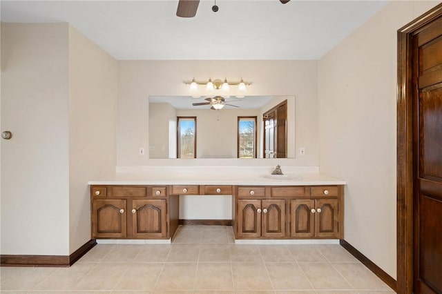 bathroom with ceiling fan, baseboards, tile patterned flooring, and vanity