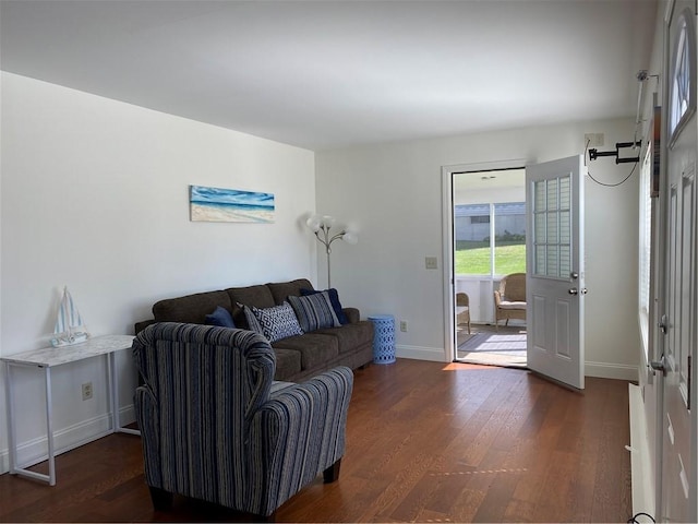 living room featuring baseboards and dark wood finished floors