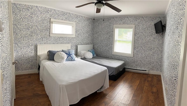 bedroom with a ceiling fan, wood-type flooring, baseboards, wallpapered walls, and a baseboard heating unit