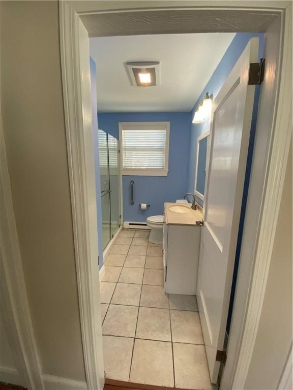 full bath featuring toilet, vanity, a shower stall, tile patterned flooring, and baseboards