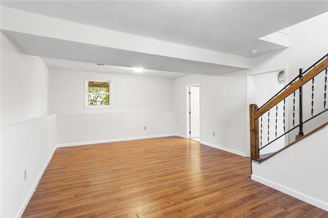 interior space with baseboards, stairs, and wood finished floors