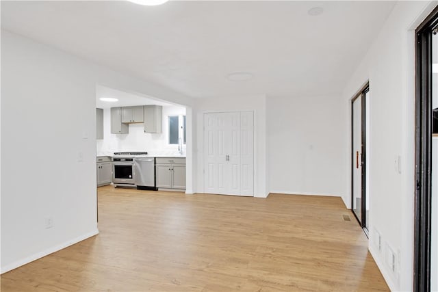 20 Holly Hill Ct, East Greenwich, RI 02818 - unfurnished living room featuring baseboards and light wood-type flooring