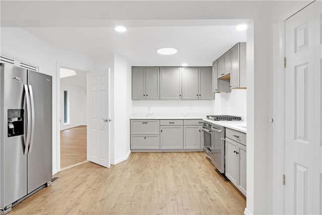 20 Holly Hill Ct, East Greenwich, RI 02818 - kitchen with gray cabinets, light countertops, stainless steel fridge with ice dispenser, light wood-style flooring, and range