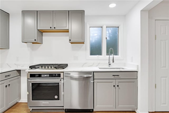 20 Holly Hill Ct, East Greenwich, RI 02818 - kitchen featuring gray cabinets, light stone counters, a sink, and stainless steel appliances