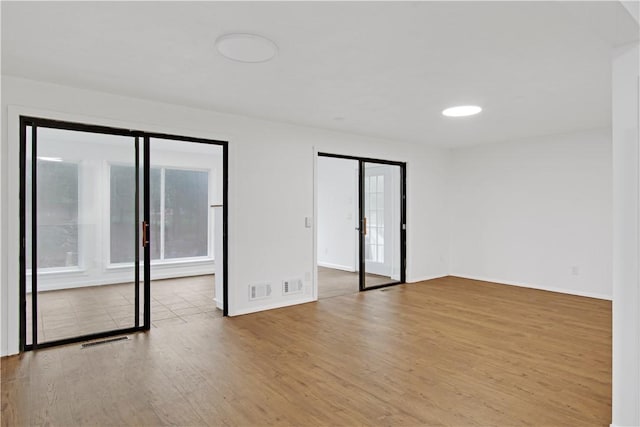 20 Holly Hill Ct, East Greenwich, RI 02818 - unfurnished room with baseboards, visible vents, and wood finished floors