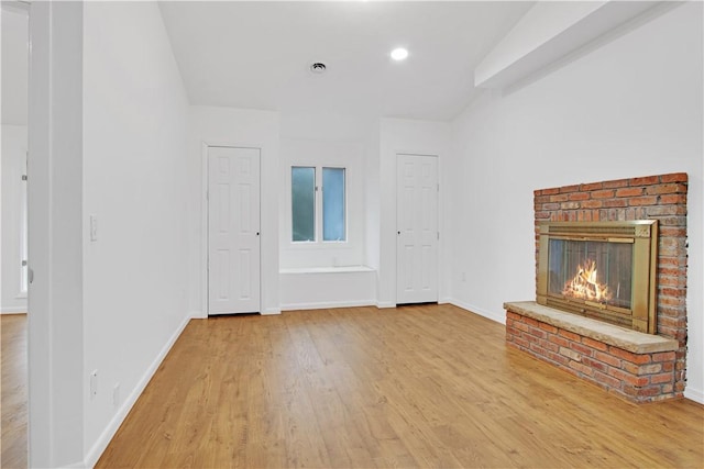 20 Holly Hill Ct, East Greenwich, RI 02818 - unfurnished living room featuring a brick fireplace, visible vents, baseboards, and wood finished floors