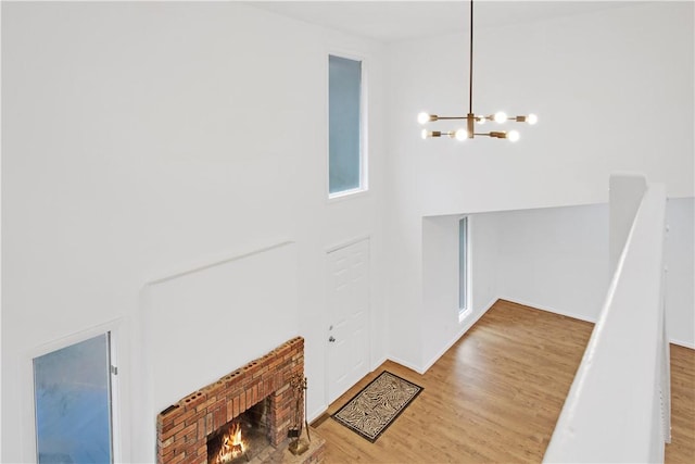 20 Holly Hill Ct, East Greenwich, RI 02818 - entryway featuring a fireplace, wood finished floors, and a chandelier