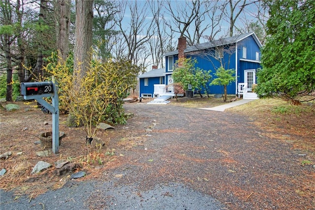20 Holly Hill Ct, East Greenwich, RI 02818 - view of front of house featuring a chimney and entry steps