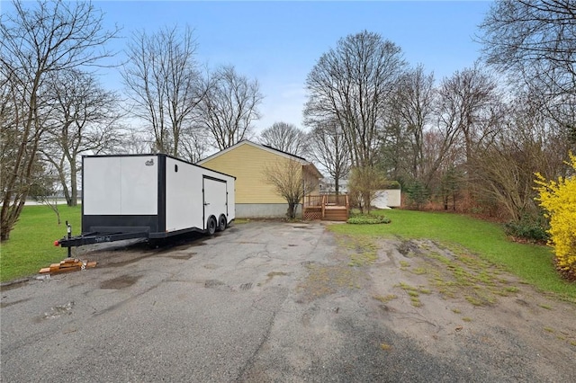 1737 Wampanoag Trl, Barrington, RI 02806 - view of green lawn featuring an outbuilding and a deck