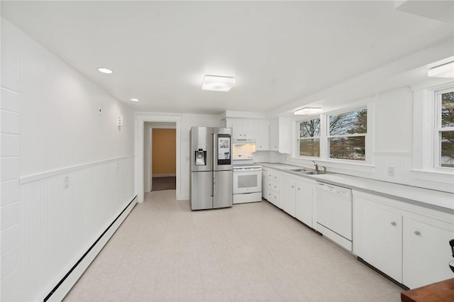 1737 Wampanoag Trl, Barrington, RI 02806 - kitchen featuring white appliances, baseboard heating, white cabinets, light countertops, and a sink
