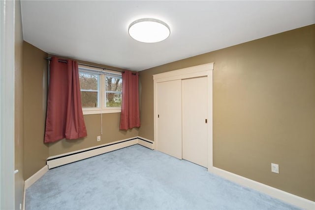 1737 Wampanoag Trl, Barrington, RI 02806 - unfurnished bedroom featuring a baseboard heating unit, carpet flooring, baseboards, and a closet