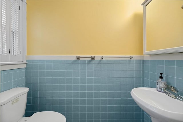 1737 Wampanoag Trl, Barrington, RI 02806 - bathroom with a sink, tile walls, toilet, and wainscoting