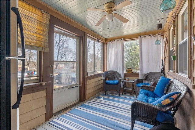 sunroom featuring a wealth of natural light and a ceiling fan