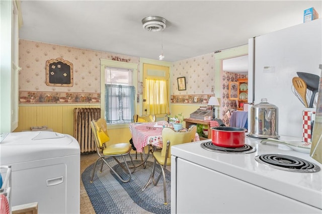 interior space featuring radiator heating unit, a wainscoted wall, and wallpapered walls