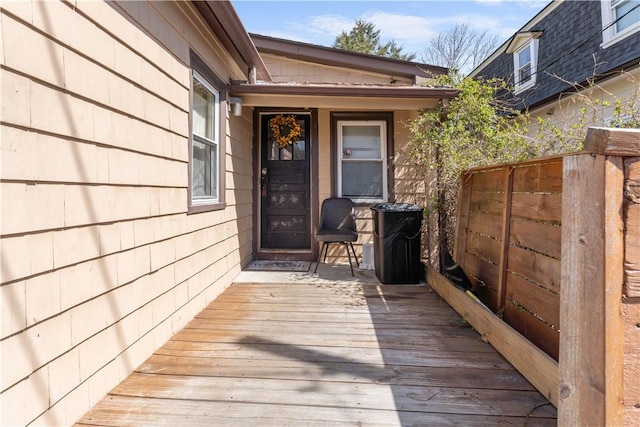 wooden terrace featuring fence