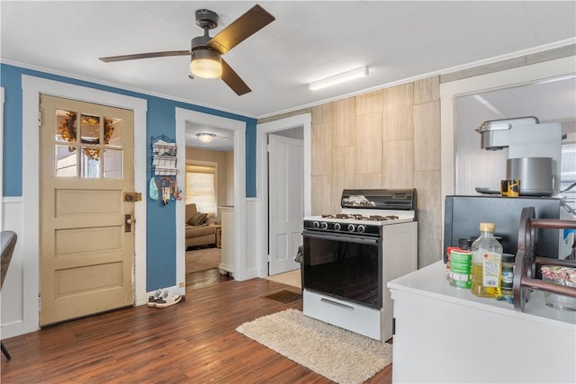 kitchen featuring modern cabinets, ceiling fan, white gas range, ornamental molding, and wood finished floors
