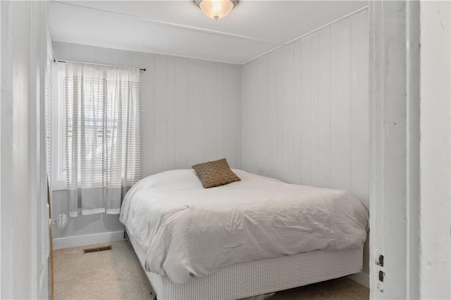 bedroom with visible vents and carpet floors