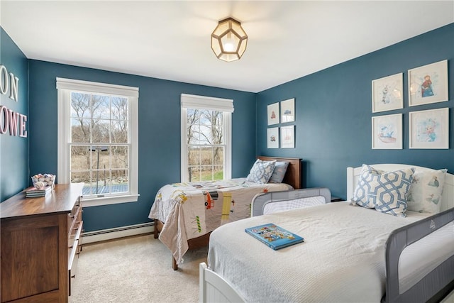 carpeted bedroom featuring baseboard heating and baseboards