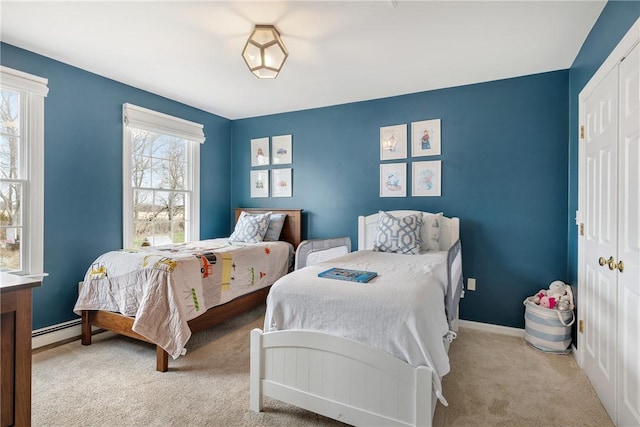 bedroom with carpet floors, baseboards, a closet, and baseboard heating