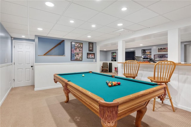 recreation room with carpet, baseboards, and a wainscoted wall