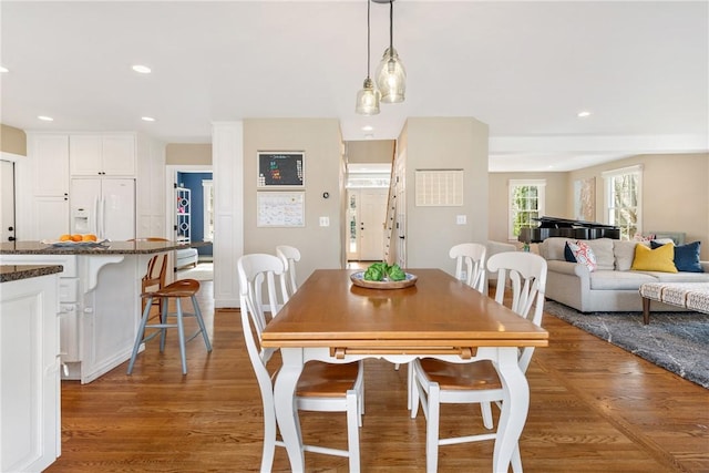 dining area with recessed lighting and wood finished floors