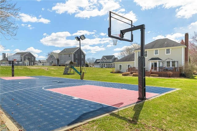 view of sport court with a residential view, basketball court, a playground, and a lawn