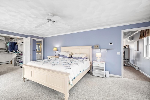 bedroom with a ceiling fan, a walk in closet, a closet, carpet flooring, and baseboard heating