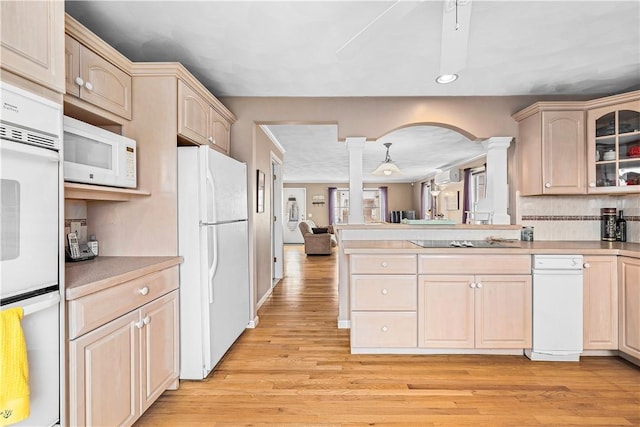 kitchen featuring recessed lighting, white appliances, light wood-style floors, decorative columns, and a peninsula
