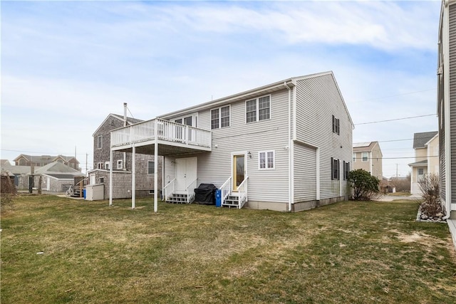 rear view of property featuring a yard and entry steps