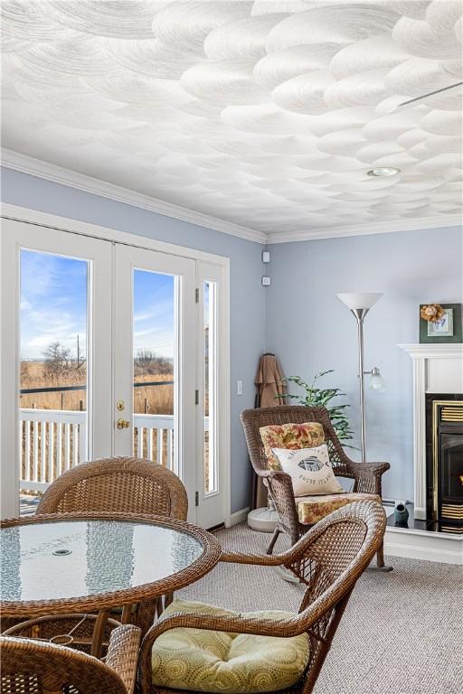 16 Elm Ave, Narragansett, RI 02882 - sitting room featuring carpet, crown molding, a warm lit fireplace, and baseboards
