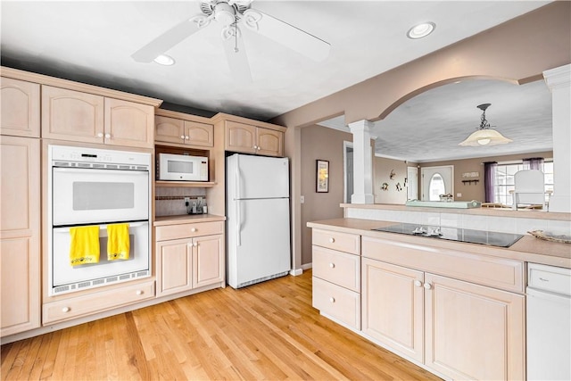 kitchen with arched walkways, decorative columns, a ceiling fan, white appliances, and light countertops