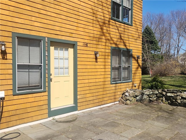 property entrance featuring a patio area