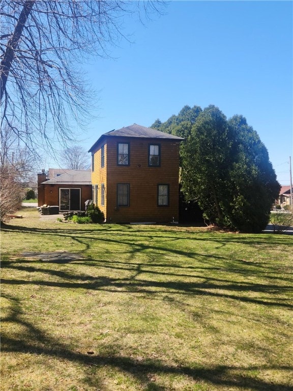 view of side of home with a lawn