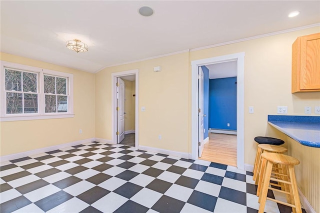 dining space with a baseboard heating unit, dark floors, and baseboards