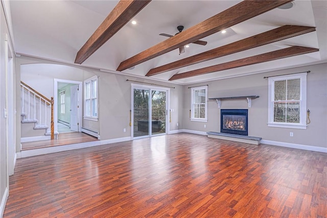 unfurnished living room featuring beamed ceiling, wood finished floors, baseboards, and stairs