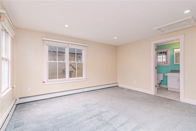 unfurnished bedroom with baseboard heating, baseboards, carpet, and recessed lighting