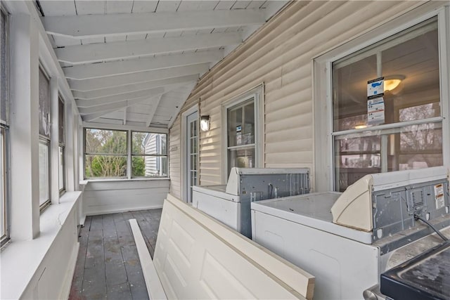 sunroom / solarium featuring washer and dryer and beam ceiling