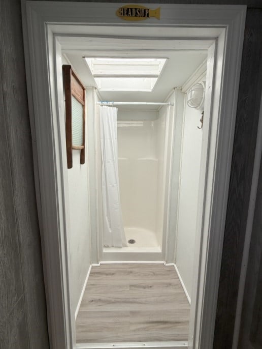 689 Succotash Rd, South Kingstown, RI 02879 - full bath with baseboards, curtained shower, and wood finished floors