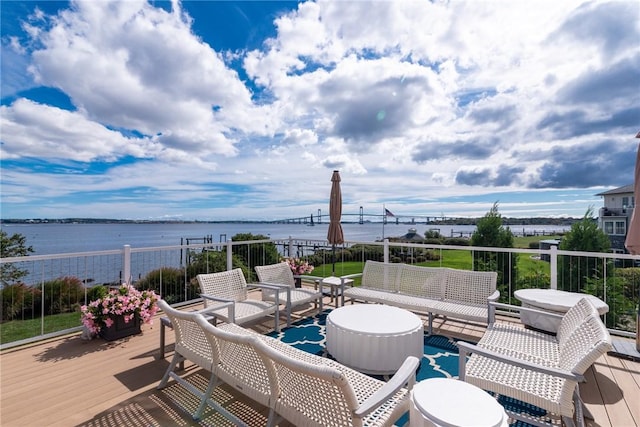 wooden terrace featuring an outdoor hangout area and a water view