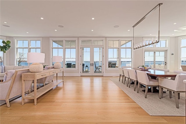 interior space featuring light wood finished floors, french doors, and recessed lighting