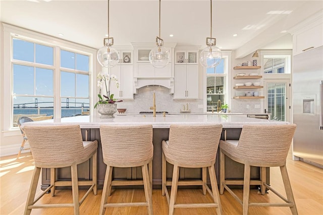 kitchen featuring light countertops, light wood-style floors, and tasteful backsplash
