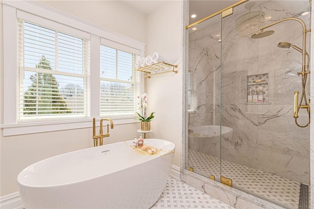 full bathroom with a freestanding tub, baseboards, and a marble finish shower