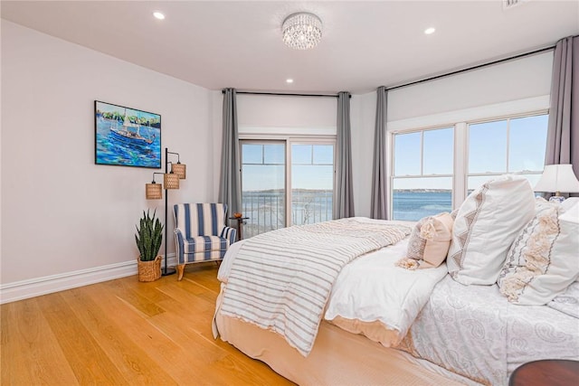 bedroom with recessed lighting, baseboards, and light wood-type flooring