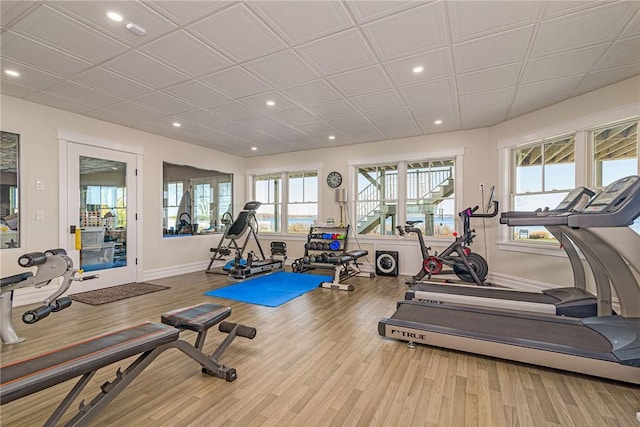 exercise room featuring recessed lighting, wood finished floors, and baseboards