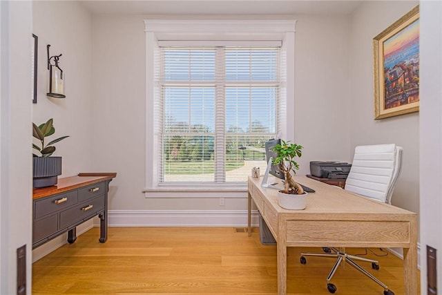office with light wood-style flooring and baseboards